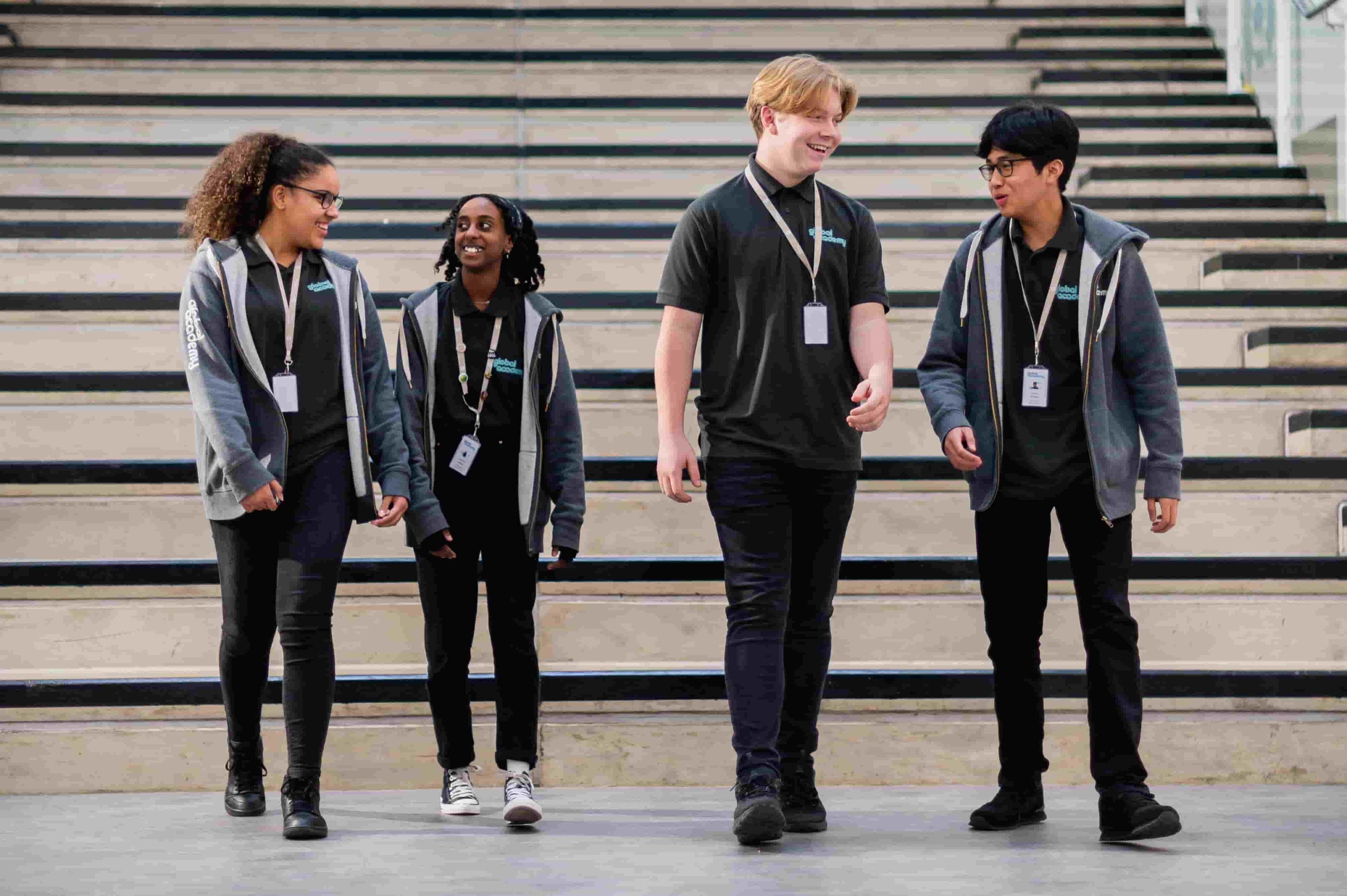 Global Academy students walking on campus smiling