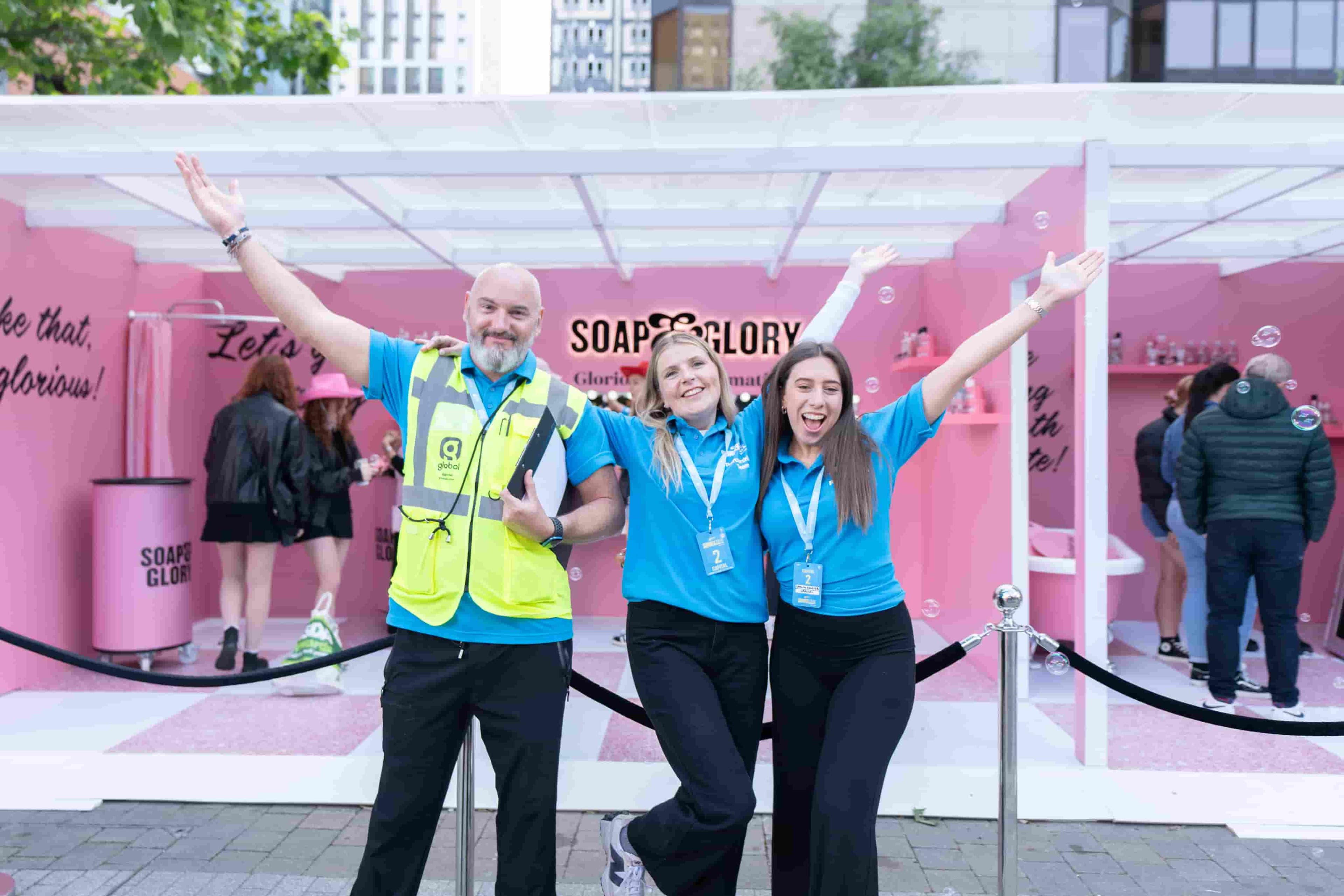 A joyful group of Global colleagues striking a pose for a memorable photo at an event.