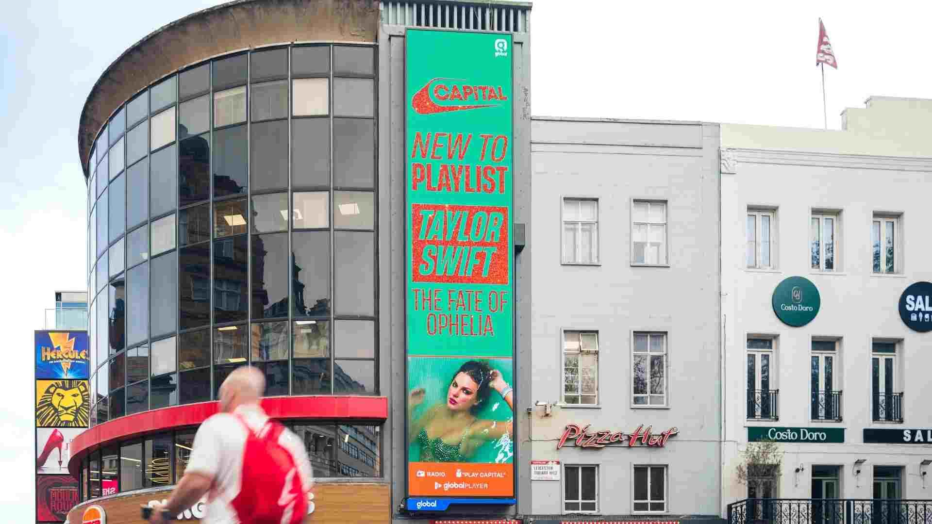 A tall vibrant billboard promoting Capital