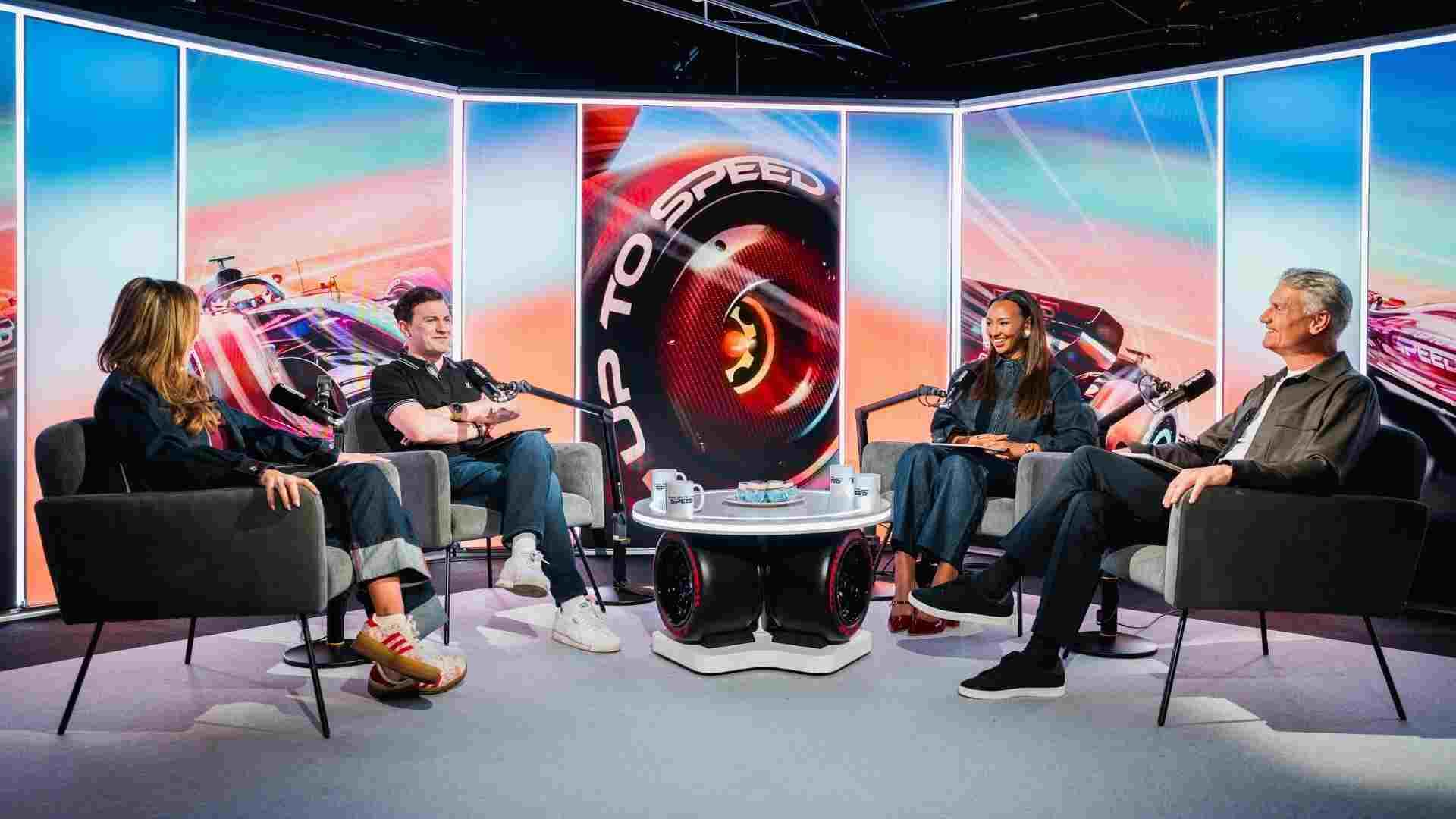 A group of podcast hosts having a discussion on set